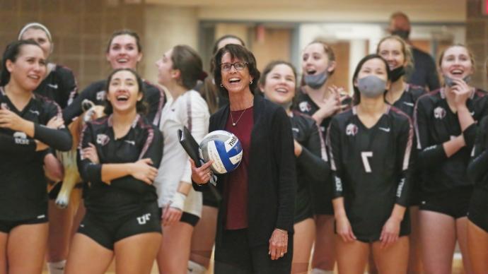 Julie Jenkins and the volleyball team celebrating 