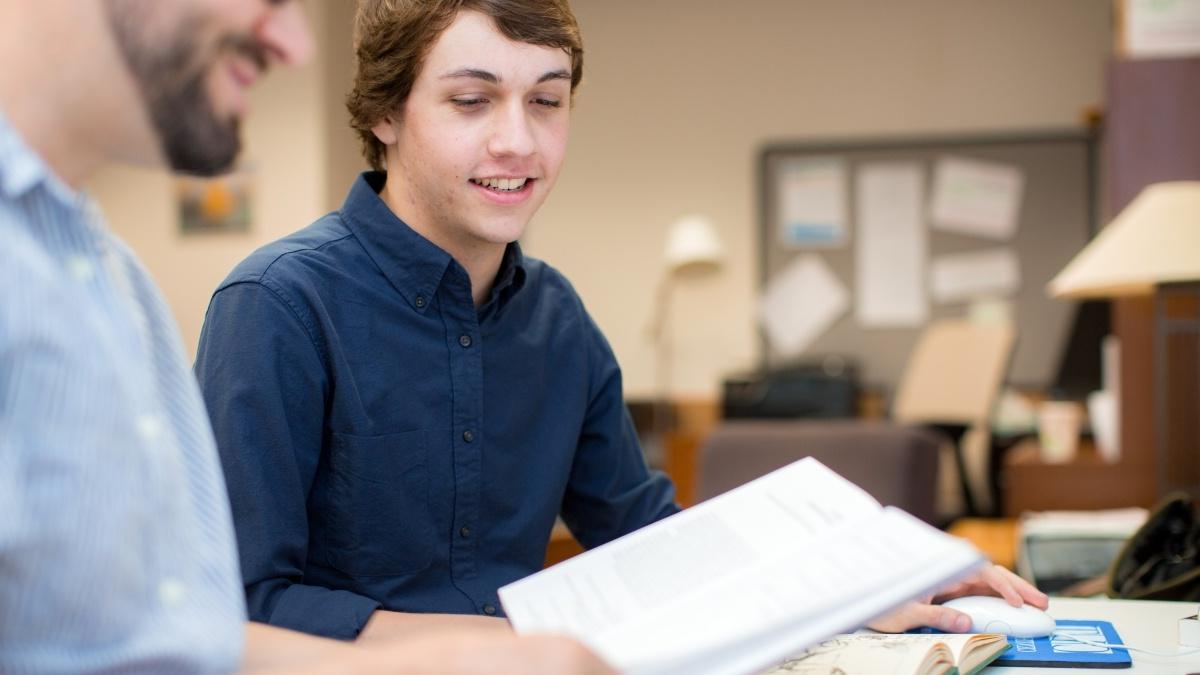 Two students discussing book